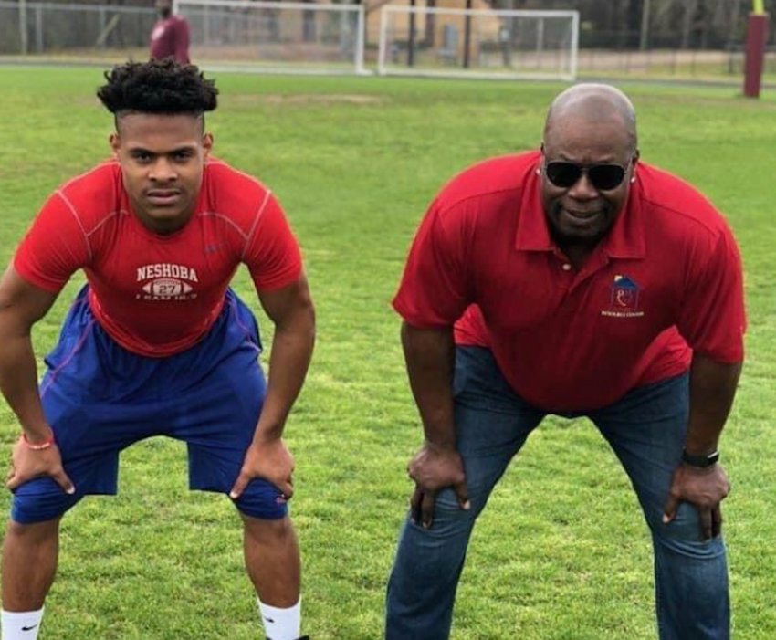 Neshoba Central running back Jarquez Hunter on the field with legend Marcus Dupree.